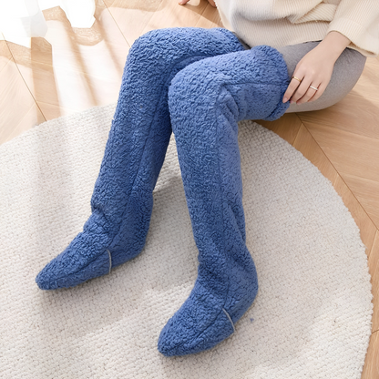 A woman wearing blue plush knee high socks.